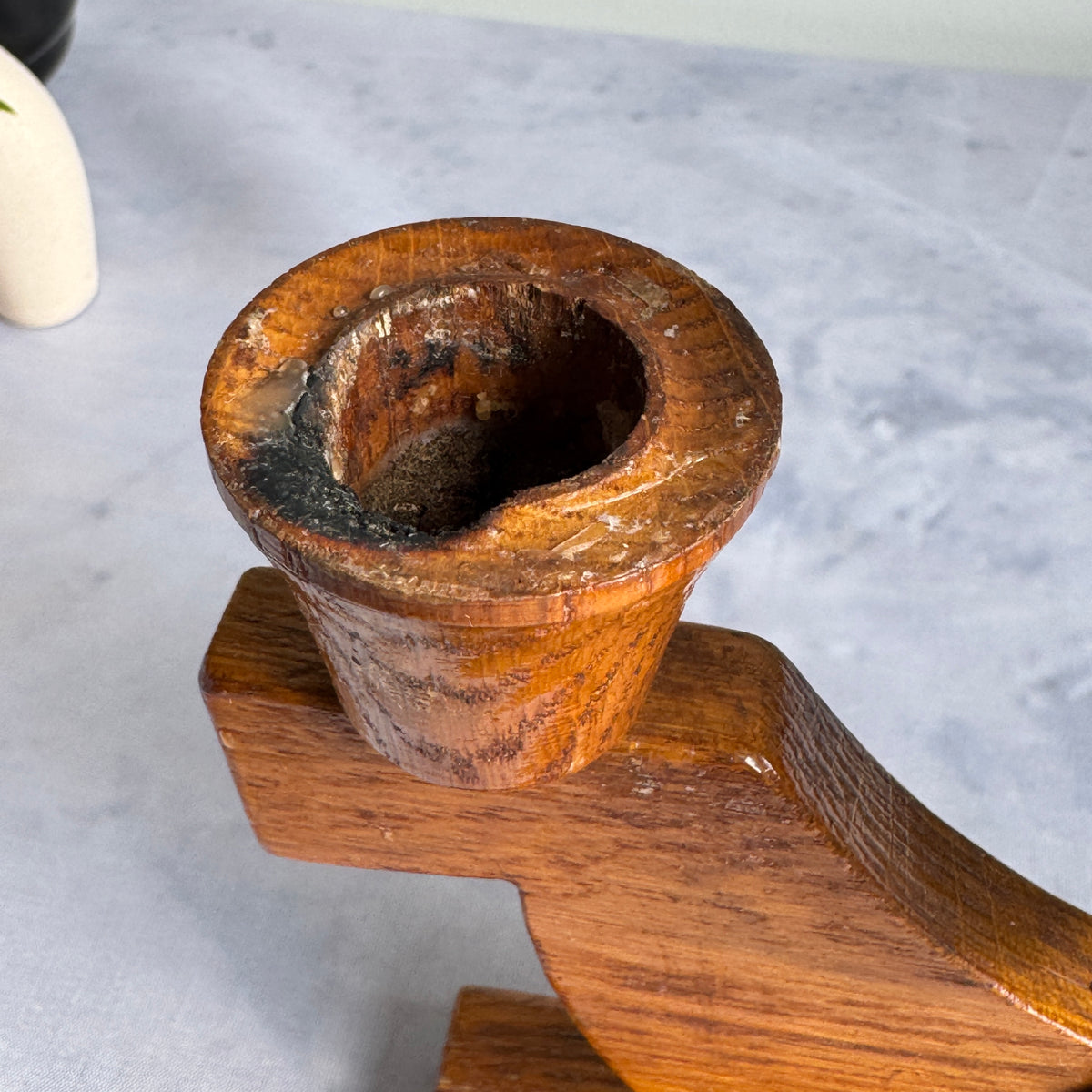 Close-up of candle cup with wax residue and darkening