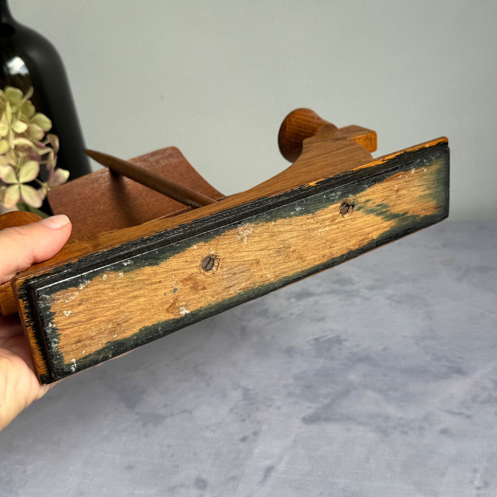 Underside of candle holder base with black paint and screws