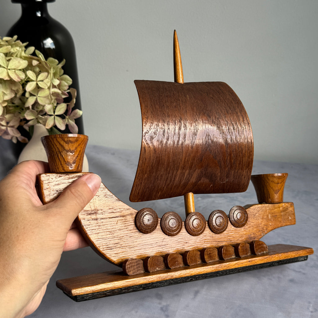 Viking ship candle holder held in hand to show scale