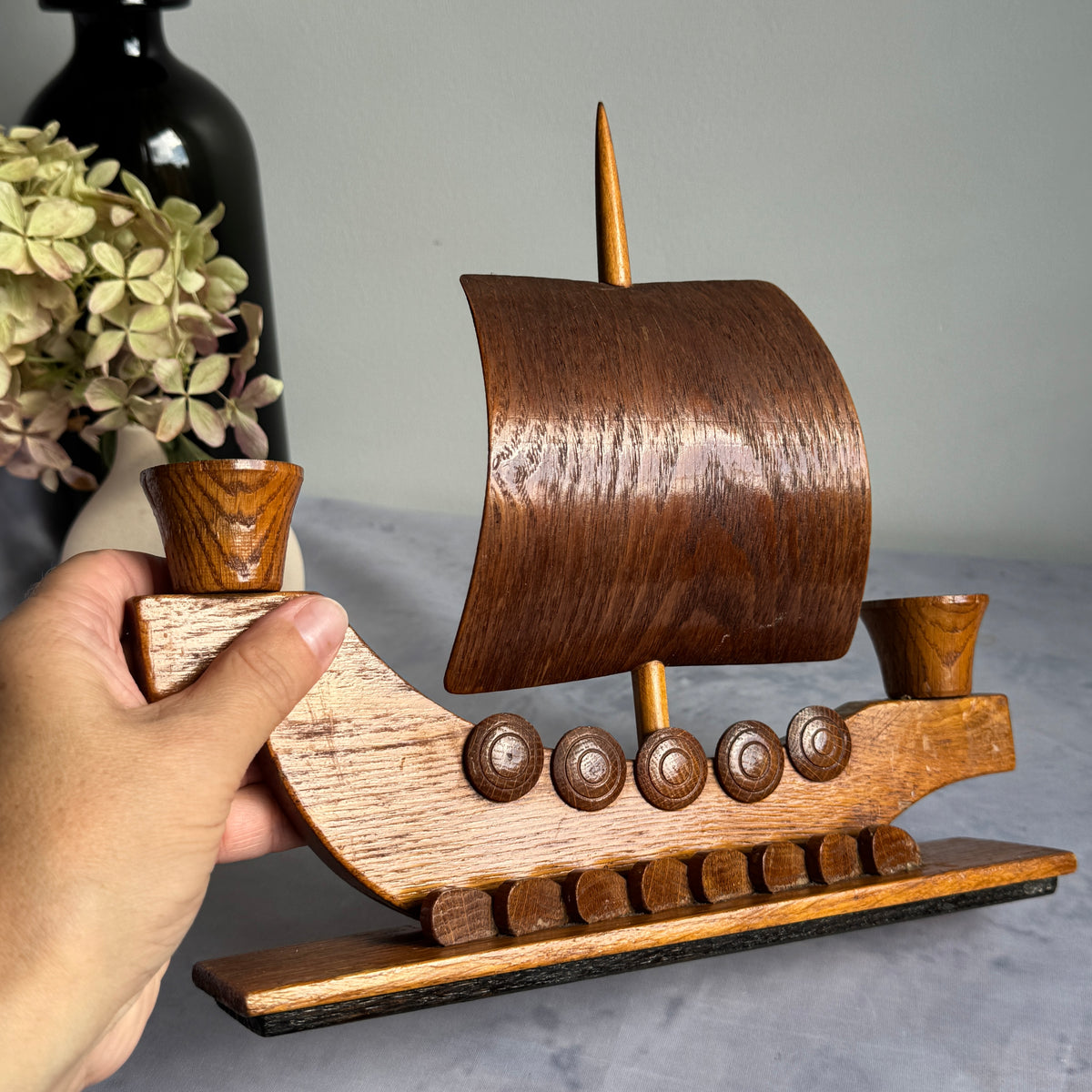 Viking ship candle holder held in hand to show scale