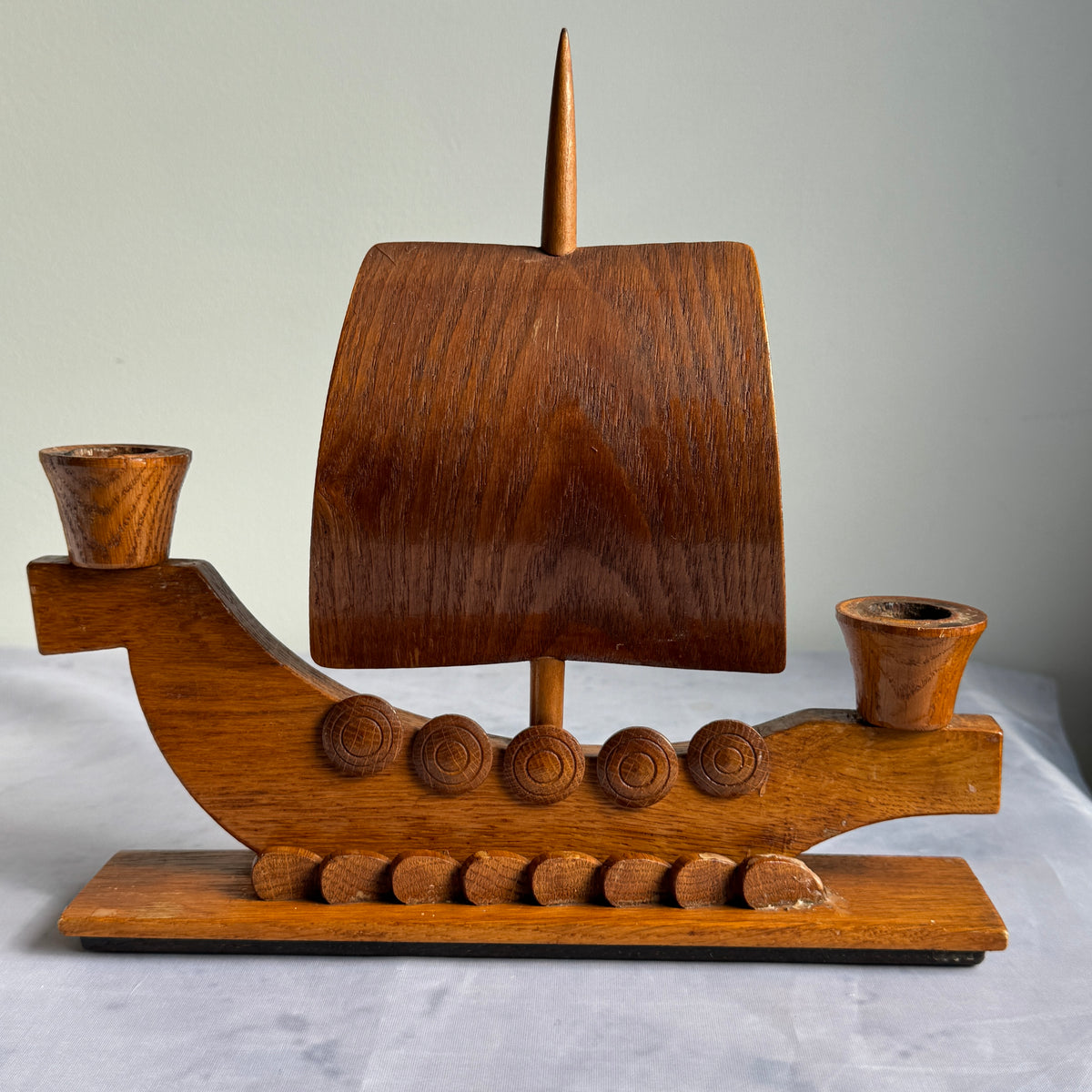 Front view of wooden Viking longship double candlestick